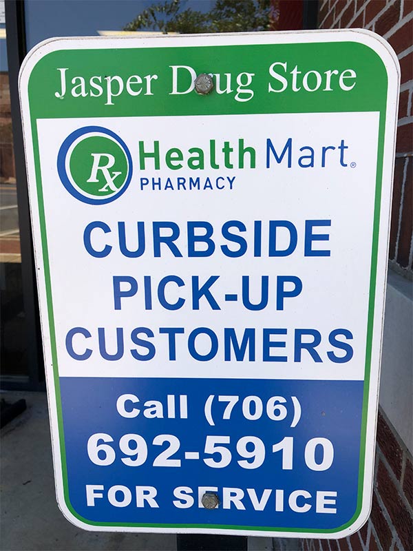 Jasper Drug Store sign about a curbside pick-up.